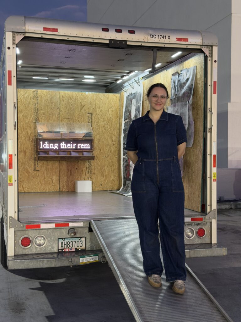 Ana Vergara standing in front of “On Belonging.” (Photo courtesy of Cargo Space)
