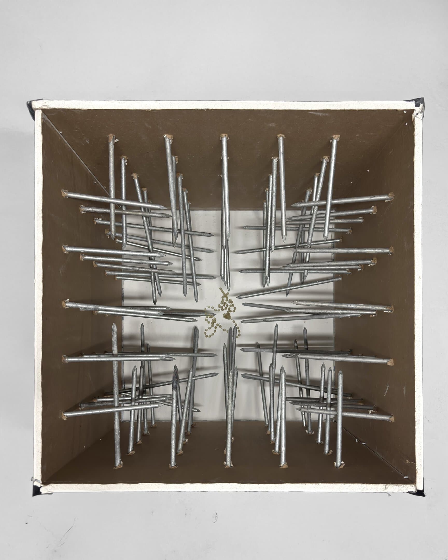 Luna Palazzolo-Daboul, Intra-mural, 2025; drywall, hot dip galvanized spikes and the artist’s grandfather’s rosary. Image courtesy the artist.