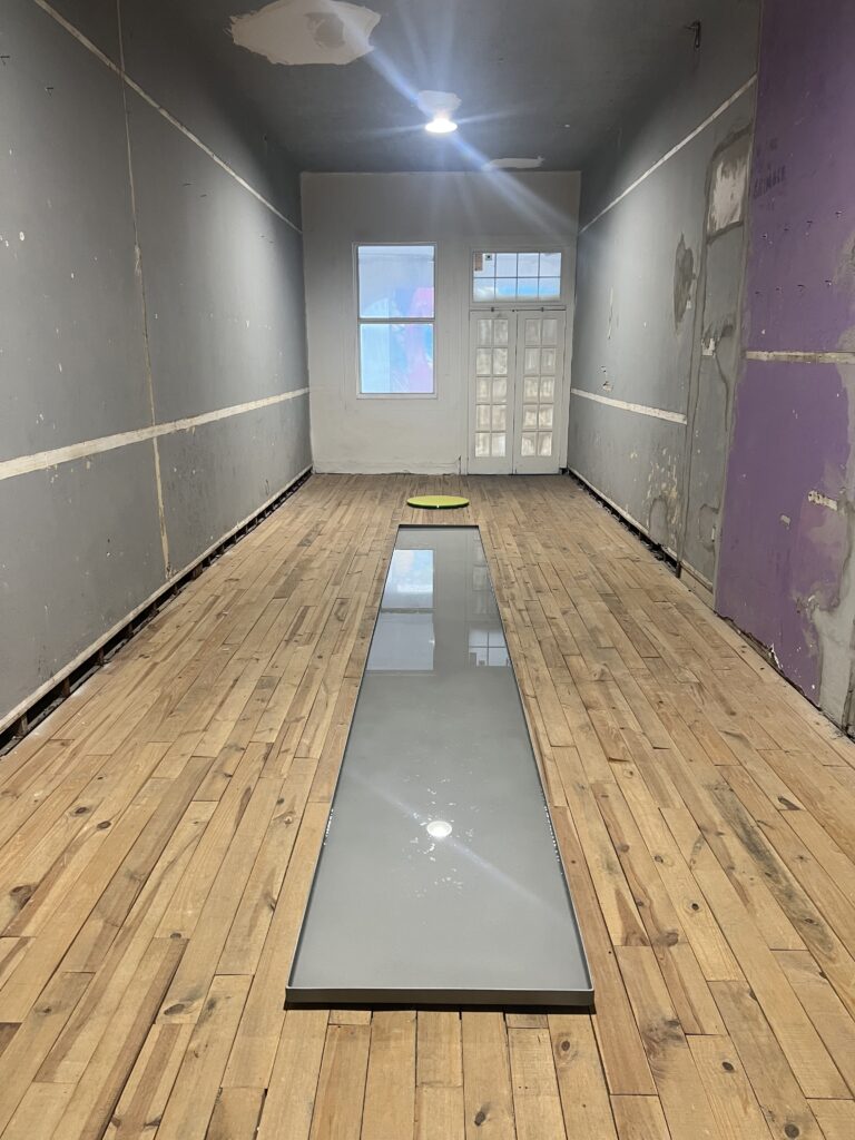 Fared Manzur’s installation at the Rice Hotel are large, shallow, opaque basins filled with water. (Photo courtesy of the artist).