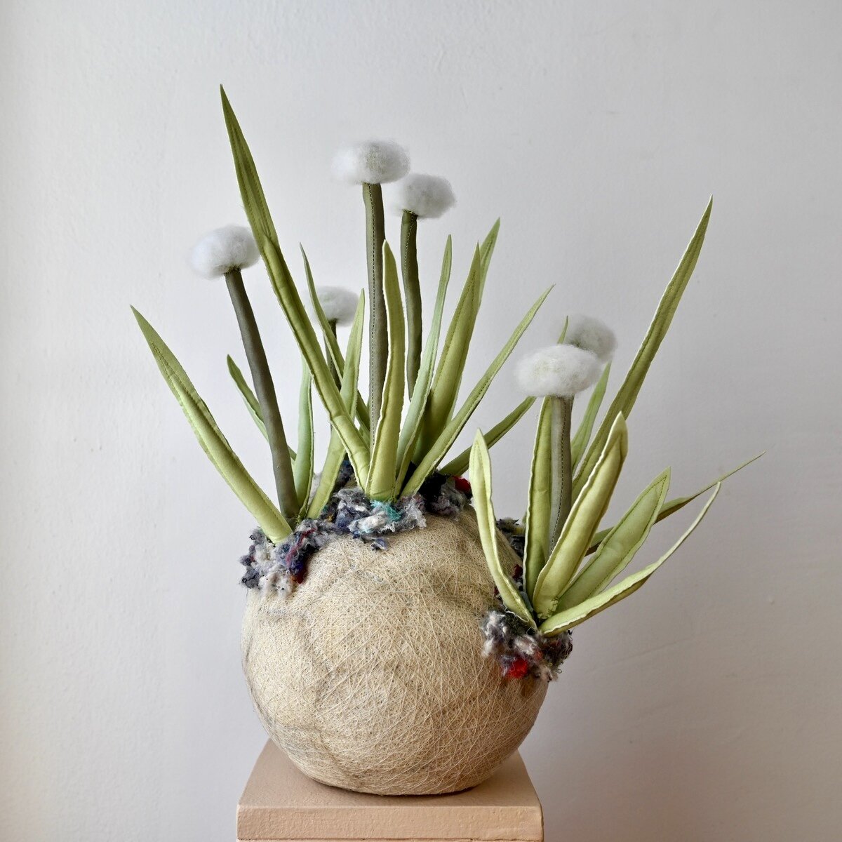 Alissa Alfonso, Pipewort ll, 2024, hand—dyed textile waste, reused fiber—fill, wire, thread, textile stabilizer; base: soccer ball bladder, textile shoddy, 15 x 15 x 15 inches (38.10 x 38.10 x 38.10 cm). Photography by and courtesy of Zachary Balber.