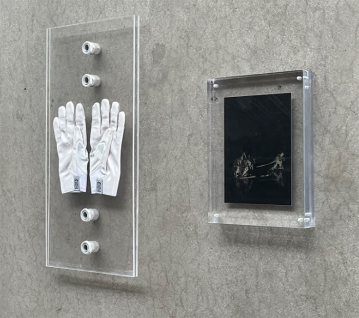 David Correa’’s Death Catalyst Gloves, 21.5” x 11.5”and still from The Machining of the Fool, 11” x 8.5”, 2024. Performance art artifacts suspended in acrylic. Photo courtesy of Laundromat Art Space. Photo linked to a video. 